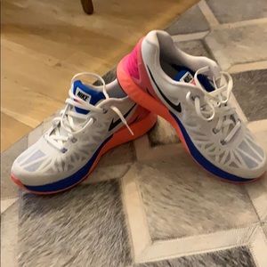 Nike white and pink running shoe.